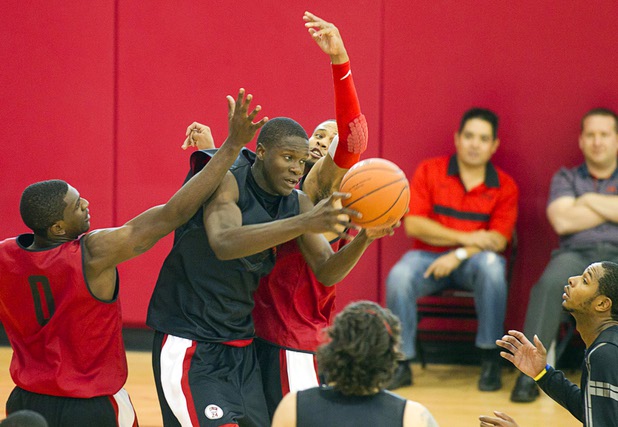 Demetris Morant, center, pulls down a rebound during the first UNLV basketball practice of the season at UNLV's Mendenhall Center Monday, Oct. 7, 2013.