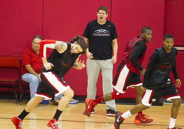 Head Coach Dave Rice, center, calls out to players during the first UNLV basketball practice of the season at UNLV's Mendenhall Center Monday, Oct. 7, 2013.