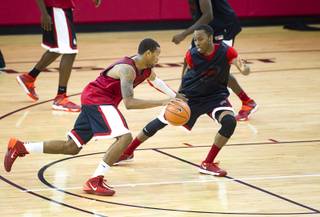 Bryce Dejean-Jones drives by Kevin Olekaibe during the first UNLV basketball practice of the season at UNLV's Mendenhall Center Monday, Oct. 7, 2013.