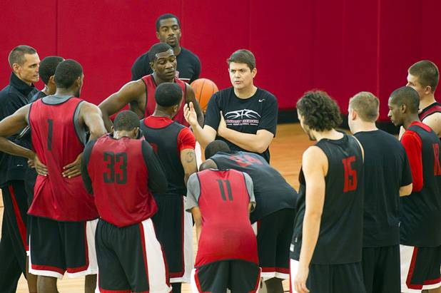 Head Coach Dave Rice talks with players during the first UNLV basketball practice of the season at UNLV's Mendenhall Center Monday, Oct. 7, 2013.