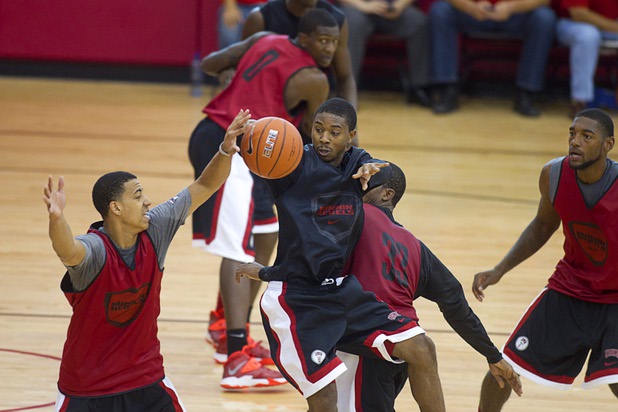 Daquan Cook, center, passes the ball during the first UNLV basketball practice of the season at UNLV's Mendenhall Center Monday, Oct. 7, 2013. 