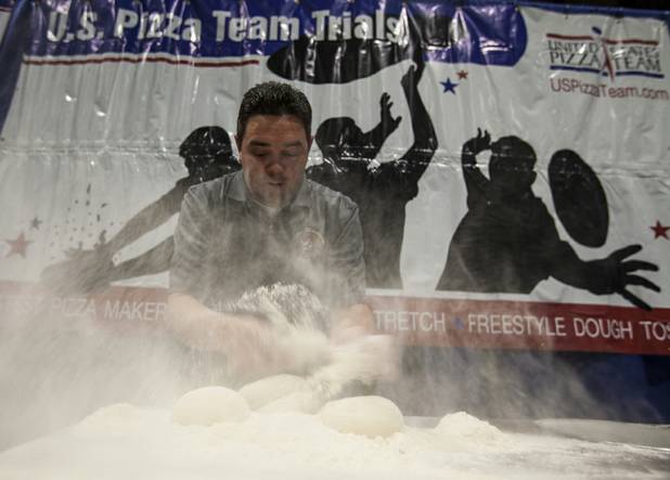 Dave Sommers of West Lafayette, Ind., stirs up some flour as he begins to create five pizzas during a timed competition during the International Baking Industry Exposition at the Las Vegas Convention Center.  As a member of the U.S. Pizza Team he's competed at the world championships in Parma, Italy. 