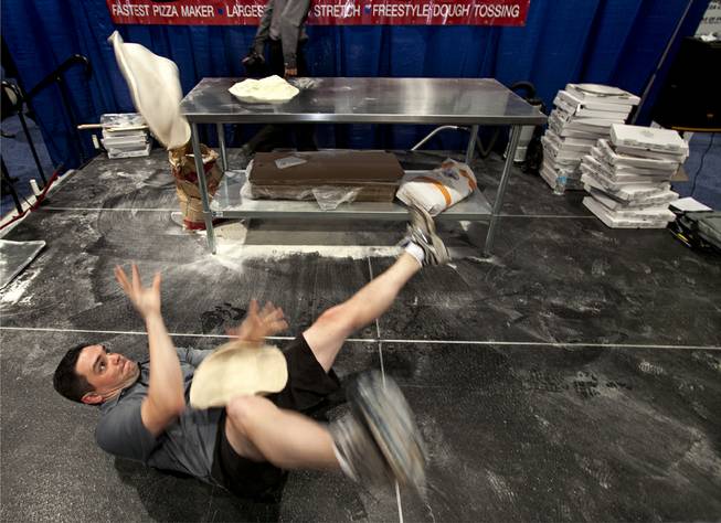 Dave Sommers of West Lafayette, Ind., hits the deck for some acrobatic practice following the day's competition during the International Baking Industry Exposition at the Las Vegas Convention Center.  As a member of the U.S. Pizza Team he's competed at the world championships in Parma, Italy and currently works for Mad Mushroom in West Lafayette. 