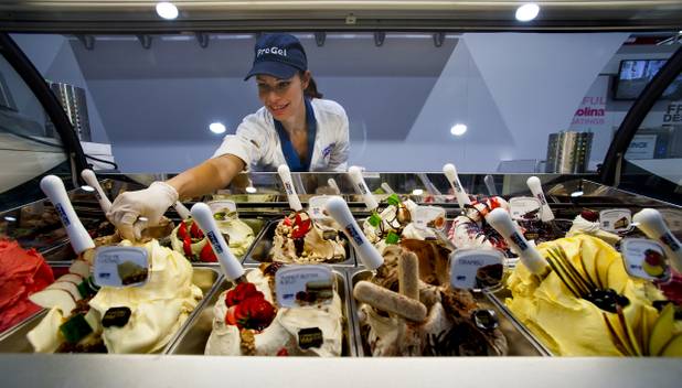 Haley Capri with PreGel reaches into the display case for another fine sample during the International Baking Industry Exposition within the Las Vegas Convention Center. Over 20,000 are on hand for North Americas largest, most comprehensive trade event of the year. 