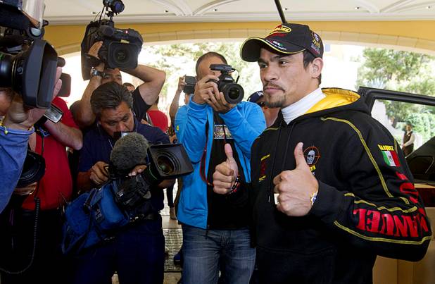Mexican boxer Juan Manuel Marquez gives two thumbs up as he arrives at the Wynn Las Vegas Resort Tuesday, Oct. 8, 2013. Marquez will challenge undefeated WBO welterweight champion Timothy Bradley Jr. at the Thomas & Mack Center Saturday.