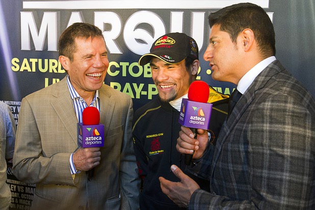 Mexican boxer Juan Manuel Marquez, center, is interviewed by Julio Cesar Chavez Sr., left, and Carlos Aguilar of Azteca Deportes at the Wynn Las Vegas Resort Tuesday, Oct. 8, 2013. Marquez will challenge undefeated WBO welterweight champion Timothy Bradley Jr. at the Thomas & Mack Center Saturday.