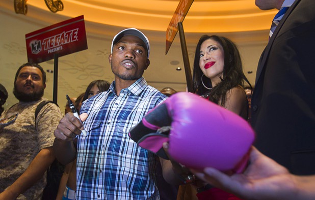 Undefeated WBO welterweight champion Timothy Bradley Jr.   hands a boxing glove back to a fan after autographing it at the Wynn Las Vegas Resort Tuesday, Oct. 8, 2013. Bradley will defend his title against Juan Manuel Marquez of Mexico at the Thomas & Mack Center Saturday.