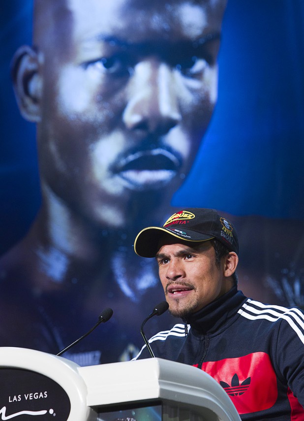 Mexican boxer Juan Manuel Marquez speaks during a news conference at the Wynn Las Vegas Resort Wednesday, Oct. 9, 2013. Marquez will challenge undefeated WBO welterweight champion Timothy Bradley Jr.  for the title at the Thomas & Mack Center Saturday. An image of Bradley appears on a banner behind Marquez.