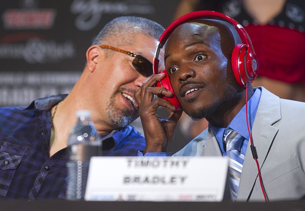 Undefeated WBO welterweight champion Timothy Bradley Jr., right, listens to trainer Joel Diaz during a news conference at the Wynn Las Vegas Resort Wednesday, Oct. 9, 2013. Bradley will defend his title against Juan Manuel Marquez of Mexico at the Thomas & Mack Center Saturday.