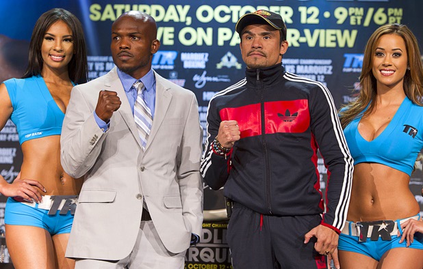 Undefeated WBO welterweight champion Timothy Bradley Jr., left, and Juan Manuel Marquez of Mexico are flanked by Top Rank Knockout girls during a news conference at the Wynn Las Vegas Resort Wednesday, Oct. 9, 2013. Bradley will defend his title against Marquez at the Thomas & Mack Center Saturday.