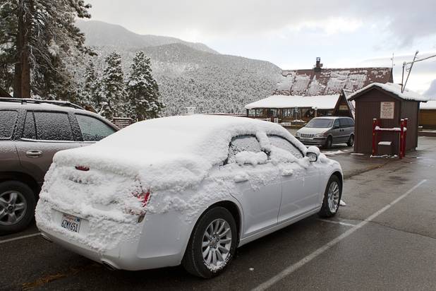 Snow covers cars in the parking lot of the Mt. Charleston Lodge on Mount Charleston Thursday, Oct. 10, 2013.
