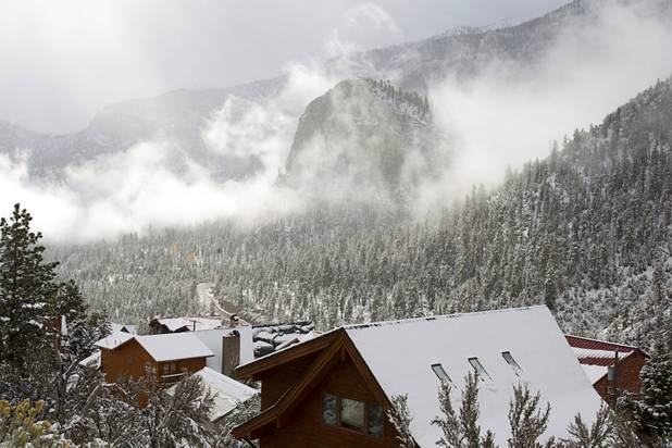 Low clouds surround Cathedral Rock after a snowstorm on Mount Charleston Thursday, Oct. 10, 2013.