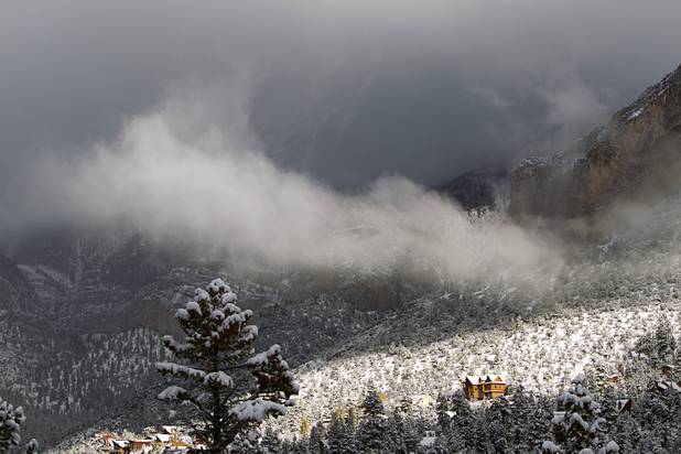 Low clouds hand over the Echo Canyon subdivision after a snowstorm on Mount Charleston Thursday, Oct. 10, 2013.