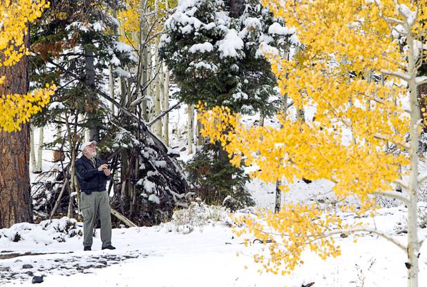 Les Farris of Summerlin takes photos by the Mary Jane Falls trailhead after a snowstorm on Mount Charleston Thursday, Oct. 10, 2013.
