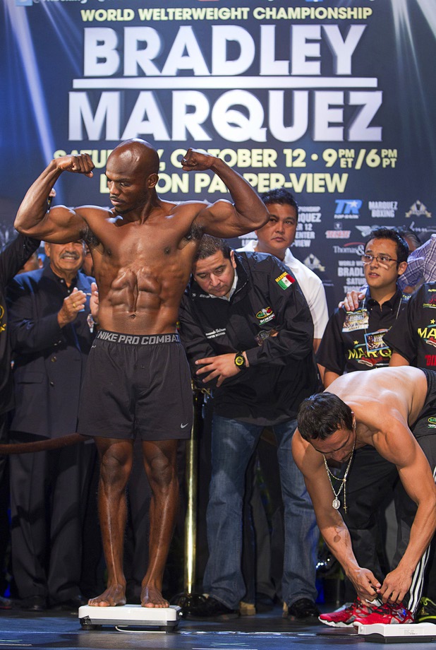 Undefeated WBO welterweight champion Timothy Bradley Jr.  poses on the scale during an official weigh-in at the Wynn Las Vegas Friday, Oct. 11, 2013. Bradley will defend his title against Juan Manuel Marquez (R) of Mexico at the Thomas & Mack Center on Saturday.