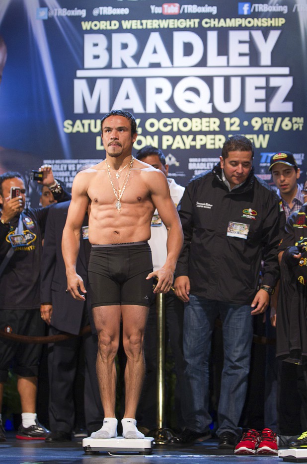 Juan Manuel Marquez of Mexico stands on a scale during an official weigh-in at the Wynn Las Vegas Friday, Oct. 11, 2013. Marquez will challenge undefeated WBO welterweight champion Timothy Bradley Jr.  for the title at the Thomas & Mack Center on Saturday.