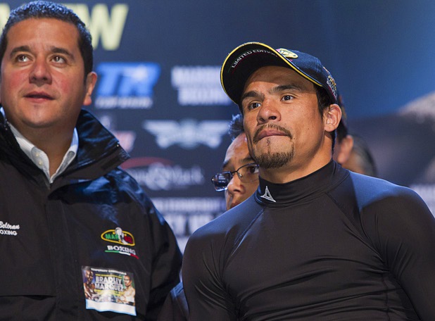 Juan Manuel Marquez (R) of Mexico arrives for an official weigh-in at the Wynn Las Vegas Friday, Oct. 11, 2013. Mexican boxing promoter Fernando Beltran is at left. Marquez will challenge undefeated WBO welterweight champion Timothy Bradley Jr.  for the title at the Thomas & Mack Center on Saturday.