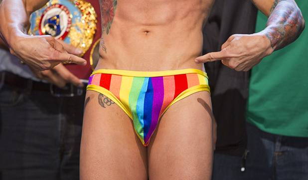 Featherweight boxer Orlando Cruz of Puerto Rico points to his rainbow-colored briefs during an official weigh-in at the Wynn Las Vegas Friday, Oct. 11, 2013. Cruz, boxing's first openly gay fighter, and Orlando Salido of Mexico will fight for a vacant WBO featherweight championship at the Thomas & Mack Center on Saturday.
