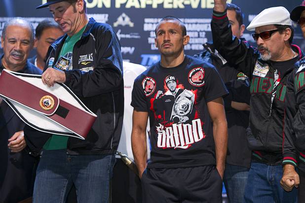 Featherweight boxer Orlando Salido (C) of Mexico arrives for an official weigh-in at the Wynn Las Vegas Friday, Oct. 11, 2013. Salido and Orlando Cruz of Puerto Rico will fight for a vacant WBO featherweight championship at the Thomas & Mack Center on Saturday.