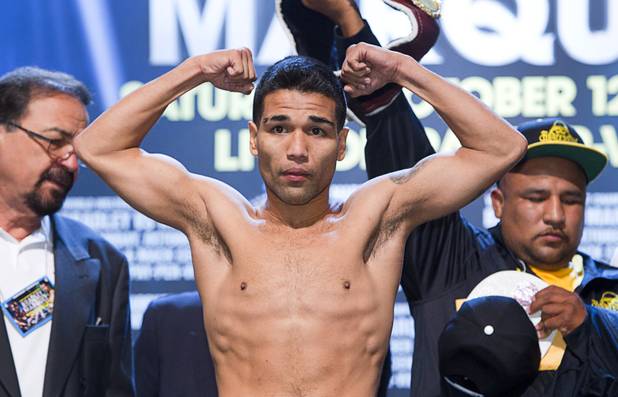 Featherweight boxer Jose Ramirez of Mexico poses on the scale during an official weigh-in at the Wynn Las Vegas Friday,, Oct. 11, 2013. Two-time Olympic gold medalist Vasyl Lomachenko of Ukraine will make his pro debut against Ramirez at the Thomas & Mack Center on Saturday.