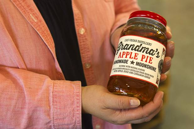 Katalin Racz holds a mason jar of the Las Vegas Distillery's newest spirit, Grandma's Apple Pie Moonshine, during an unveiling and tasting at the distillery in Henderson Saturday, Oct. 12, 2013. The distillery will feature additional tastings on Oct. 19 and 26.