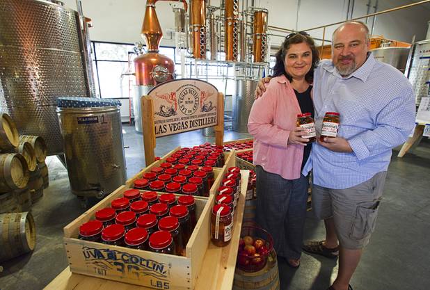 Las Vegas Distillery owners George and Katalin Racz pose with mason jars of their newest spirit, Grandma's Apple Pie Moonshine, during an unveiling and tasting at the distillery in Henderson Saturday, Oct. 12, 2013. The distillery will feature additional tastings on Oct. 19 and 26.