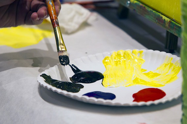 Chris Berry works on a painting during a class at the Buzz'N Brushes art studio in the Orleans Sunday, Oct. 13, 2013.  The studio combines art and entertainment for beginners and shares space with a bar and pizza kitchen.