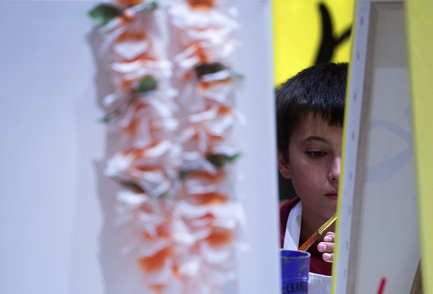 Zach Lewis, 12, works on a painting during a class at the Buzz'N Brushes art studio in the Orleans Sunday, Oct. 13, 2013.  The studio combines art and entertainment for beginners and shares space with a bar and pizza kitchen.