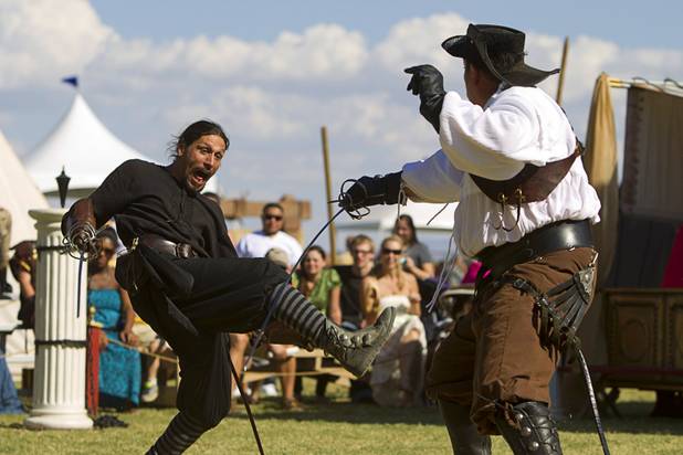 Nature of Mercy's "Guido" (Chris Mitri), left, and "Capt. Sir Richard Griffin" (Tawn Jones) duel during the Age of Chivalry Renaissance Festival at Sunset Park Sunday, Oct. 13, 2013.