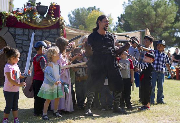 Nature of Mercy's "Guido" (Chris Mitri), center, is subdued by young volunteers during the Age of Chivalry Renaissance Festival at Sunset Park Sunday, Oct. 13, 2013.