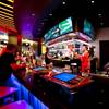 A bartender adds some flair as he tosses alcohol bottles for patrons at the renovated Catalyst Bar on Monday, Oct. 14, 2013, in The Quad.