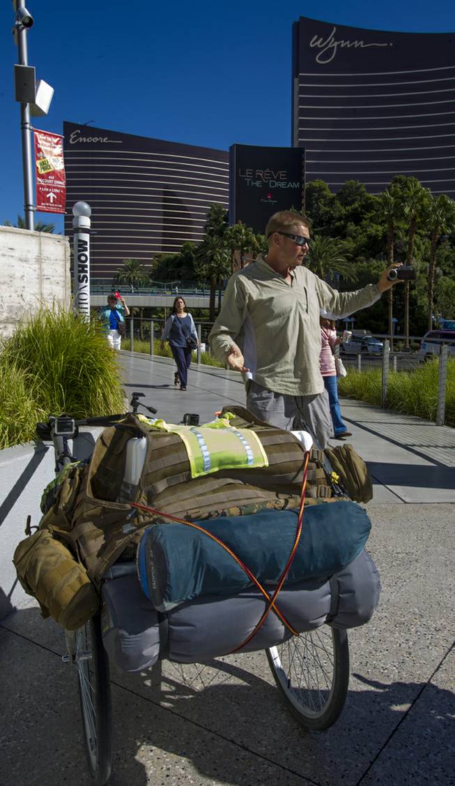 “The Walking Man” Karl Bushby documents his walk along Las Vegas Boulevard South on Monday, Oct. 14, 2013, with his cart “The Beast” on his way to Caesars Palace for a three-day stay.   