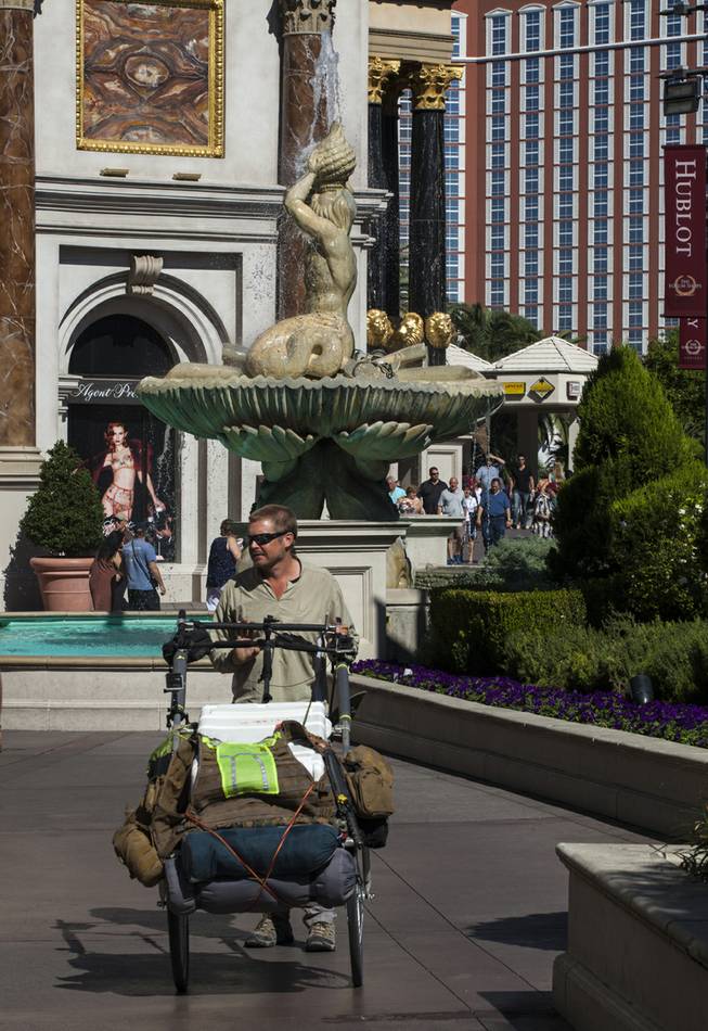 “The Walking Man” Karl Bushby makes his way along Las Vegas Boulevard South on Monday, Oct. 14, 2013, with his cart “The Beast” on his way to Caesars Palace for a three-day stay.