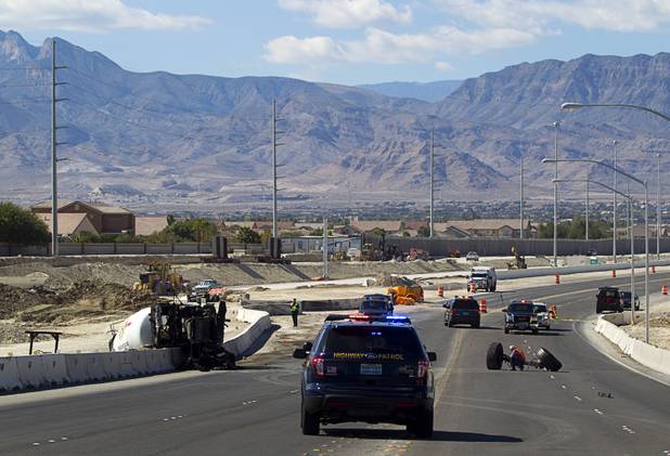 Nevada Highway Patrol troopers and investigators look over the scene of a fatal crash involving a cement truck on the northern 215 beltway near Jones Boulevard Tuesday, Oct. 15, 2013. The accident has closed the beltway in both directions between Jones Boulevard and Sky Pointe Drive. 