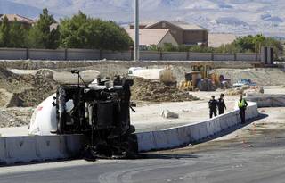 Nevada Highway Patrol troopers and investigators look over the scene of a fatal crash involving a cement truck on the northern 215 beltway near Jones Boulevard Tuesday, Oct. 15, 2013. The accident has closed the beltway in both directions between Jones Boulevard and Sky Pointe Drive.