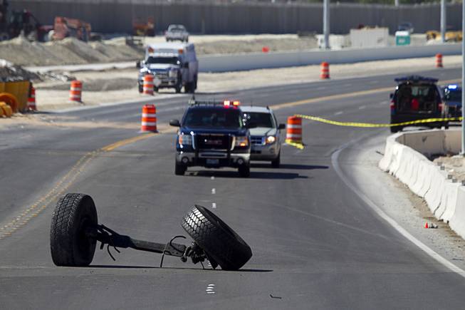 The front axle of a cement truck is shown in the roadway at the scene of a fatal crash on the northern 215 beltway near Jones Boulevard Tuesday, Oct. 15, 2013. The accident has closed the beltway in both directions between Jones Boulevard and Sky Pointe Drive.