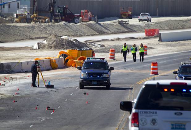 An Nevada Highway Patrol trooper takes measurements after a fatal crash involving a cement truck on the northern 215 beltway near Jones Boulevard Tuesday, Oct. 15, 2013. The cement truck apparently stuck the wall, then continued along the wall eastbound before turning over and catching fire, said NHP officer Jeremie Elliott. The accident has closed the beltway in both directions between Jones Boulevard and Sky Pointe Drive.