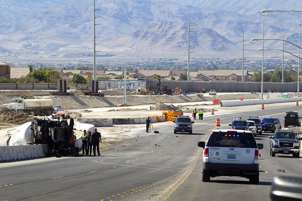 Nevada Highway Patrol troopers investigate a fatal crash involving a cement truck on the northern 215 beltway near Jones Boulevard Tuesday, Oct. 15, 2013. The cement truck apparently stuck the wall, then continued along the wall eastbound before turning over and catching fire, said NHP officer Jeremie Elliott. The accident has closed the beltway in both directions between Jones Boulevard and Sky Pointe Drive.