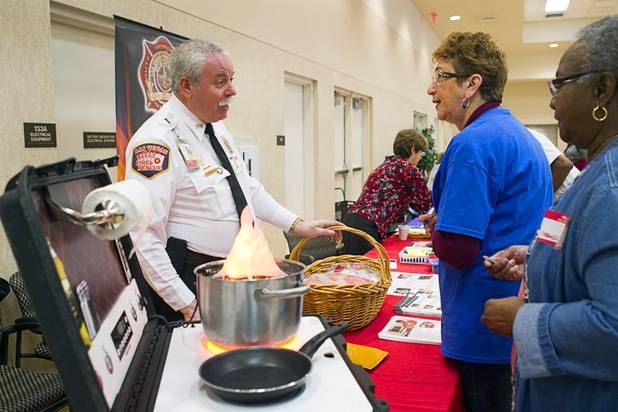 City of Las Vegas Fire PIO Tim Szymanski, left, talks with Marlene Moran during a senior safety fair at the East Las Vegas Community Center, 250 North Eastern Ave., Tuesday, Oct. 15, 2013.