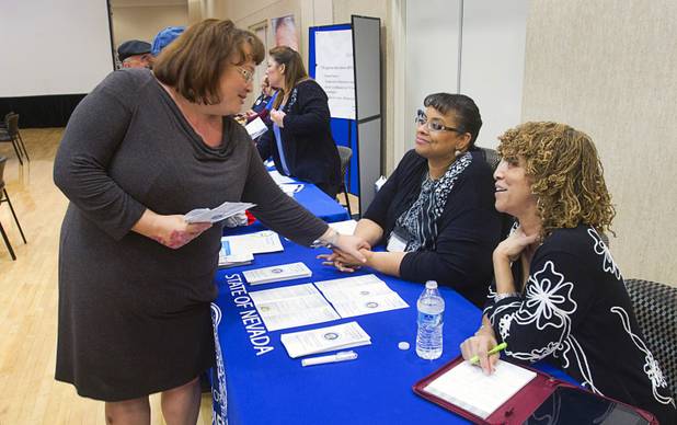 Annette Scott, left, of Safe House talks with Sherlene Simpson, an ombudsman with the Nevada Governor's Office for Consumer Health Assistance, and Fatima Parker. a program assistant with the Office of Minority Health, during a senior safety fair at the East Las Vegas Community Center, 250 North Eastern Ave., Tuesday, Oct. 15, 2013.