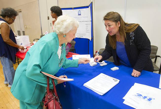 September LeMay, right, a certified information referral specialist, talks with Fran Drewrey, a member of the City of Las Vegas Senior Citizen's Advisory Board, about 2-1-1 during a senior safety fair at the East Las Vegas Community Center, 250 North Eastern Ave., Tuesday, Oct. 15, 2013. The 2-1-1 telephone number connects people with important community services and volunteer opportunities.