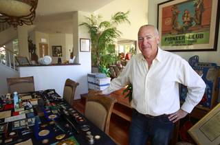 Steve Cutler poses by a small sampling of his collection of Las Vegas memorabilia at his home Wednesday, Oct. 16, 2013. Cutler, founder of Casino Legends Hall of Fame, used to display his collection in a museum at the Tropicana but is now looking for a new way to display the collection.