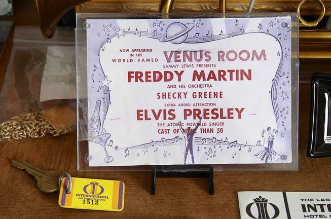 A 1956 New Frontier promotional flier, part of Steve Cutler's collection of Las Vegas memorabilia, is shown at Cutler's home Wednesday, Oct. 16, 2013. The card advertises a show with Freddy Martin, Shecky Green and, as an added attraction, "atomic-powered" singer Elvis Presley.