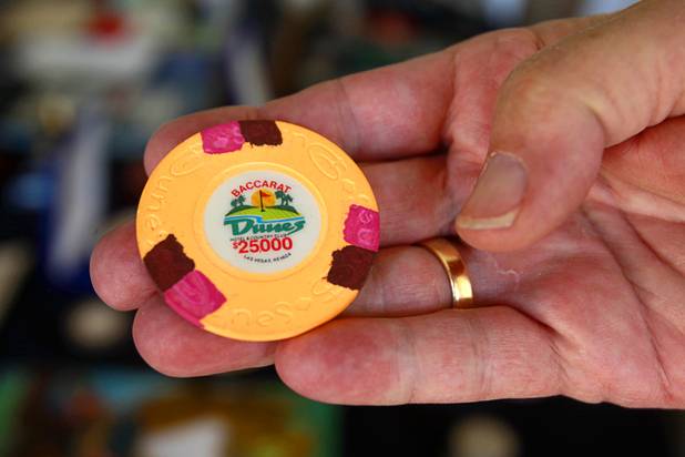 Steve Cutler holds a $25,000 baccarat gambling chip from the Dunes casino at his home Wednesday, Oct. 16, 2013. Cutler, founder of Casino Legends Hall of Fame, used to display his collection in a museum at the Tropicana but is now looking for a new way to display the collection.