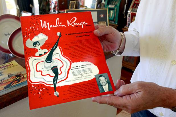 Steve Cutler holds a 1955 invitation to the opening of the Moulin Rouge casino at his home Wednesday, Oct. 16, 2013. Moulin Rouge, the first desegregated hotel casino in Las Vegas, opened in May 1955 but closed in November of the same year. Cutler, founder of Casino Legends Hall of Fame, used to display his collection in a museum at the Tropicana but is now looking for a new way to display the collection.