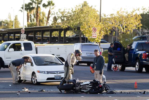 Metro Police investigators look over an accident scene after a fatal motorcycle accident on West Sahara Avenue near Buffalo Drive Wednesday, Oct. 16, 2013.
