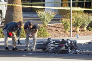 Metro Police investigators look over an accident scene after a fatal motorcycle accident on West Sahara Avenue near Buffalo Drive Wednesday, Oct. 16, 2013.