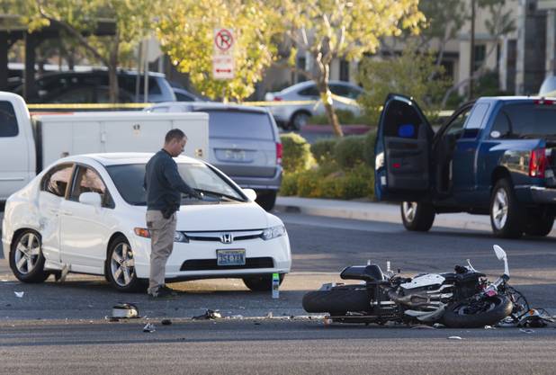A Metro Police investigator looks over the scene of a fatal motorcycle accident on West Sahara Avenue near Buffalo Drive Wednesday, Oct. 16, 2013.