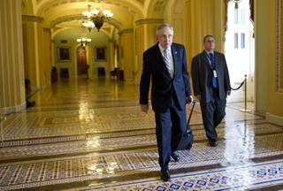 Senate Majority Leader Sen. Harry Reid, D-Nev., walks to his office after arriving on Capitol Hill on Wednesday, Oct. 16, 2013 in Washington. 