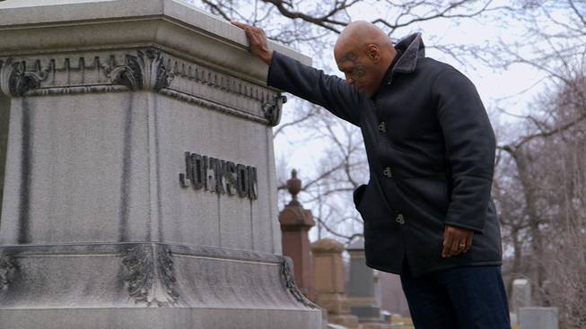 Mike Tyson at the gravestone of Jack Johnson.